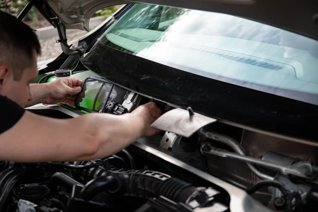 Mechanic working on a vehicle engine
